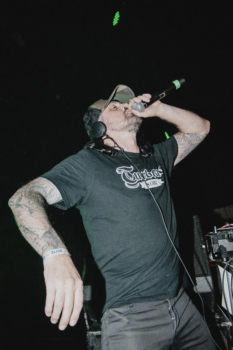 DJ Turbeau singing along into the microphone at the Alcatraz Heavy Metal Party, 2019